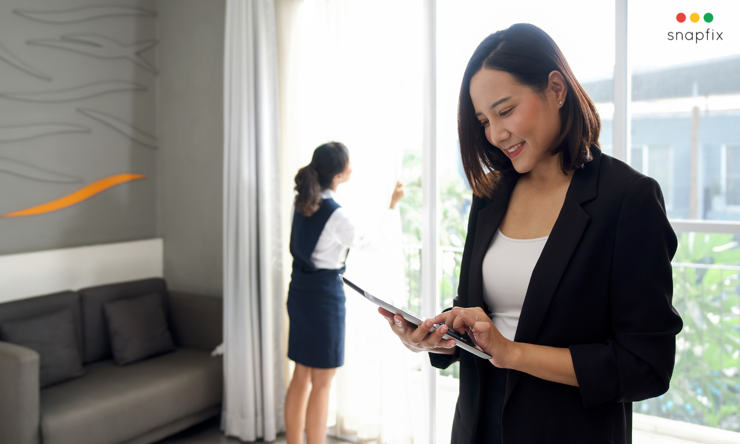 housekeeper on ipad in hotel room